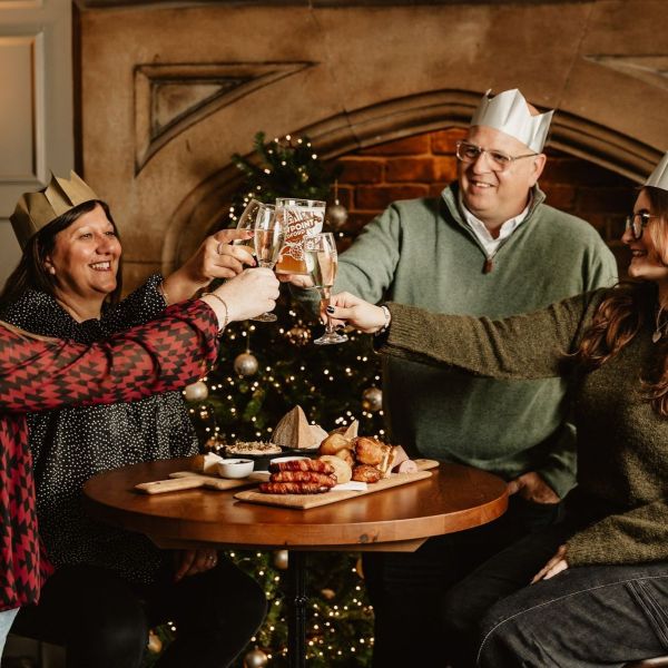 Boxing day gathering and people in festive hats and sharing food