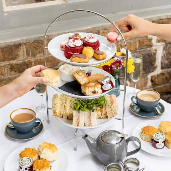 Sunday roast plated with gravy being poured slowly over the giant yorkshire pudding